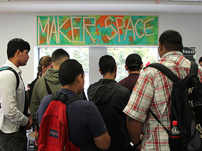 crowd of teens visiting the TeenHQ Makerspace