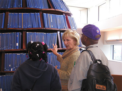 docent explaining the public art piece, Beehive, to two students